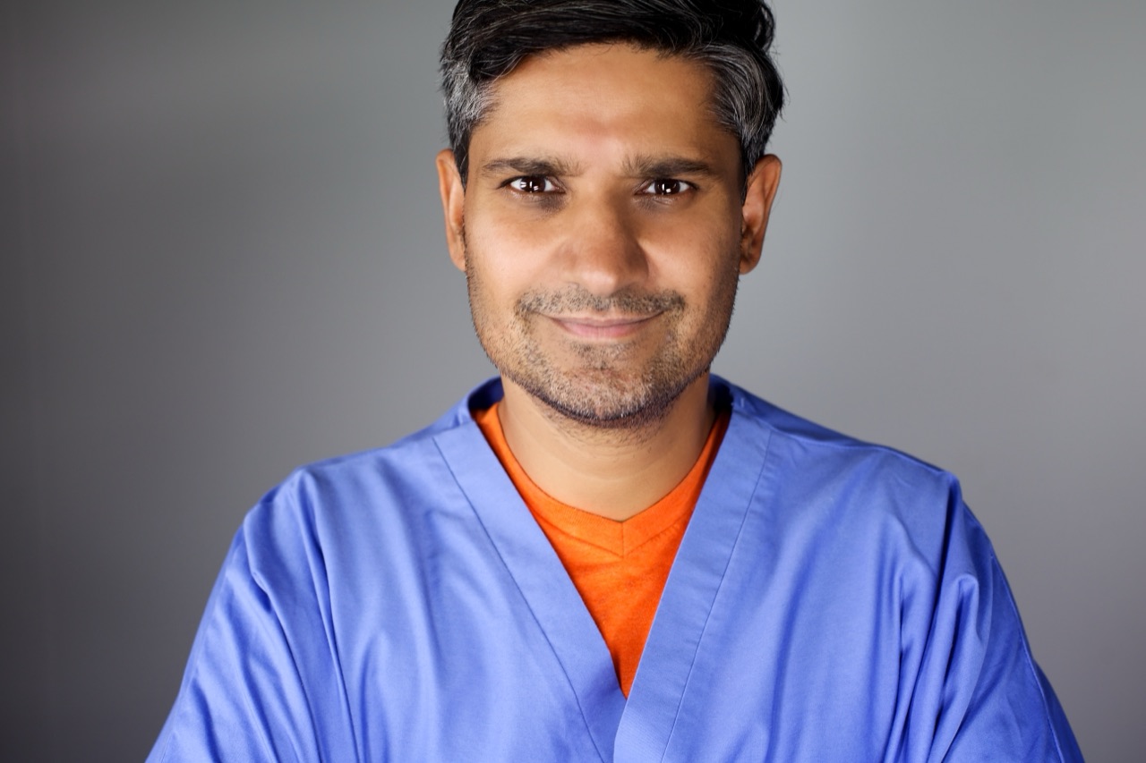 Kuldip Korotana wearing blue medical scrubs